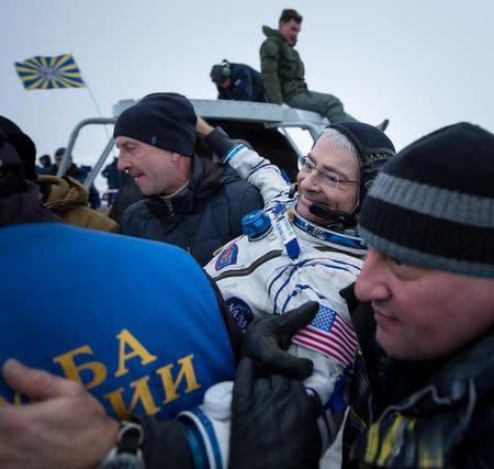 Ground personnel carry astronaut Mark Vande Hei of the U.S. is carried by ground personnel after the Soyuz MS-06 capsule landed in a remote area outside the town of Dzhezkazgan (Zhezkazgan), Kazakhstan, on February 28, 2018. Bill Ingalls/NASA/Handout via Reuters