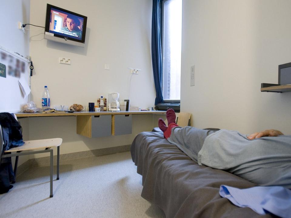 An inmate lies in his cell in the Saramaki prison in Turku, Finland in 2008.