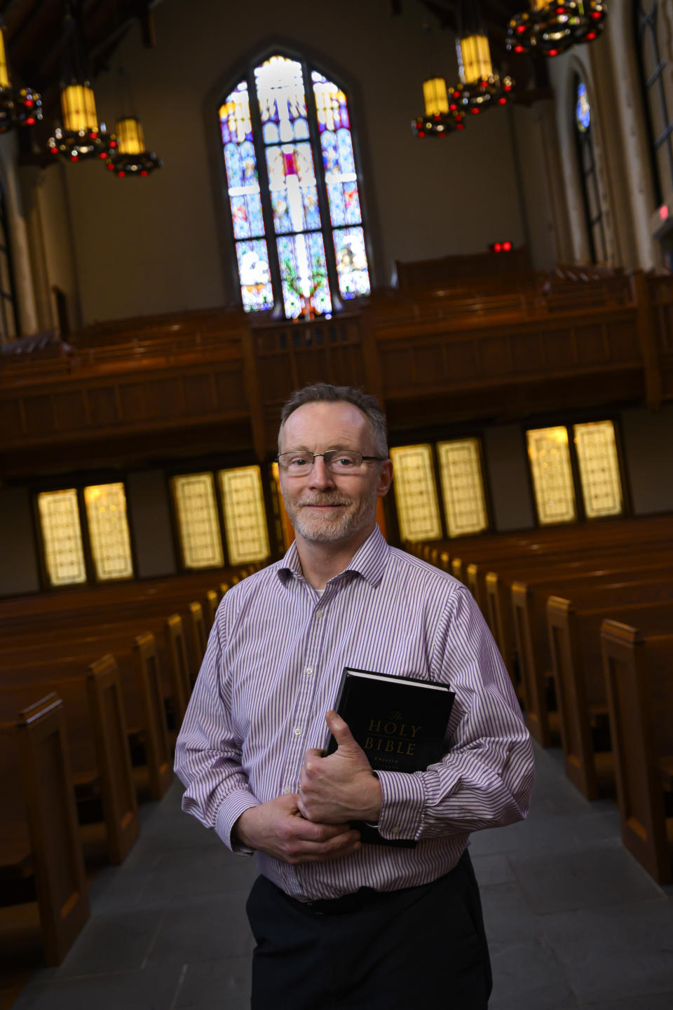 Chaplain of The Covenant School Matthew Sullivan stands in the school's church sanctuary where he lead chapel service in the past, Friday, March 22, 2024, in Nashville, Tenn. Facing the first anniversary of a tragic shooting which left six people dead, the school, which has been meeting in a temporary location, prepares to move back into it's building which is connected to the church. (AP Photo/John Amis)