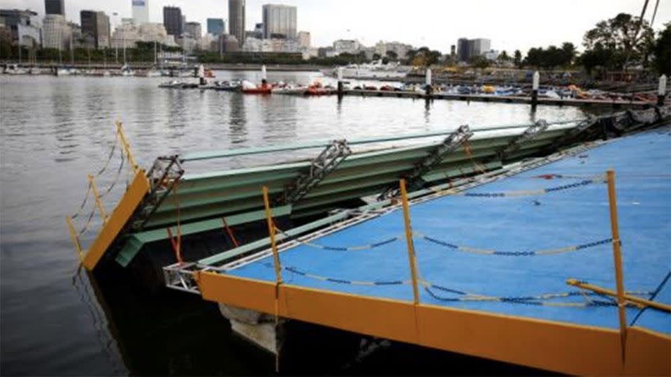 A ramp built for competitors' boats to reach the water hangs after collapsing at the Marina da Gloria sailing venue just days. Photo: Pilar Olivares / Reuters