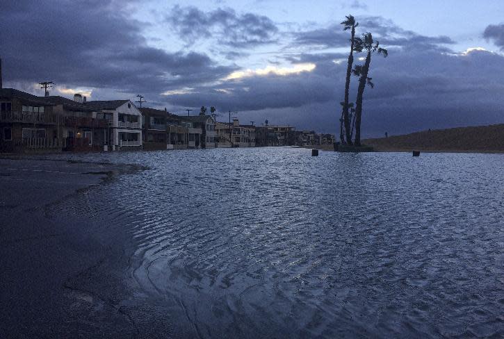 Water gathers along beach front property in Seal Beach, Calif. on Monday, Jan. 23, 2017. The tail end of a punishing winter storm system lashed California with thunderstorms and severe winds Monday after breaking rainfall records, washing out roads and whipping up enormous waves. (AP Photo/Amy Taxin)