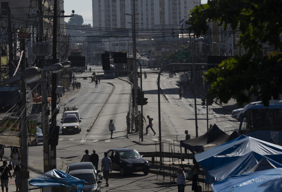 An avenue is partially empty amid increased restrictions on movements in an effort to curb the spread of the new coronavirus in the Madureira neighborhood of Rio de Janeiro, Brazil, Tuesday, May 12, 2020. (AP Photo/Silvia Izquierdo)