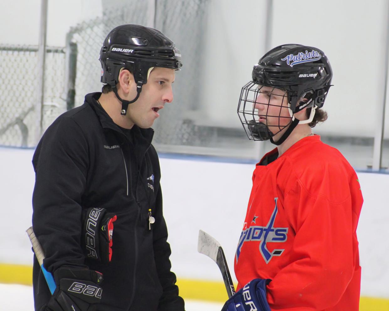 Olentangy Liberty interim coach Jonathon Falvo talks with Brady Long during practice Tuesday at Chiller North. Liberty plays St. Charles in the regional final Saturday at OhioHealth Ice Haus.