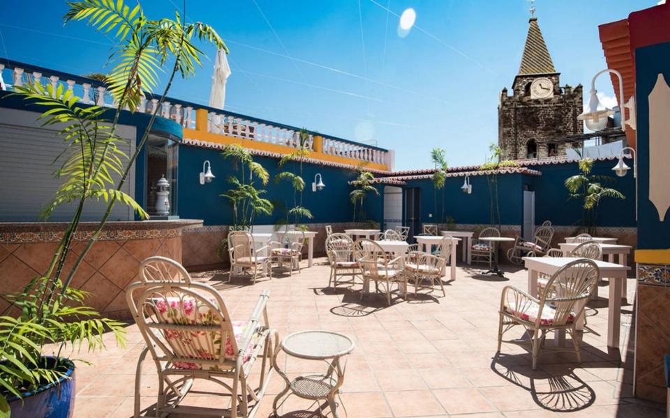 colourful rooftop bar with spire of cathedral in view