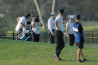 Nick Taylor, back right, talks to a rules official prior to his second shot on the ninth hole during the second round of the Sony Open golf tournament Friday, Jan. 15, 2021, at Waialae Country Club in Honolulu. (AP Photo/Jamm Aquino)