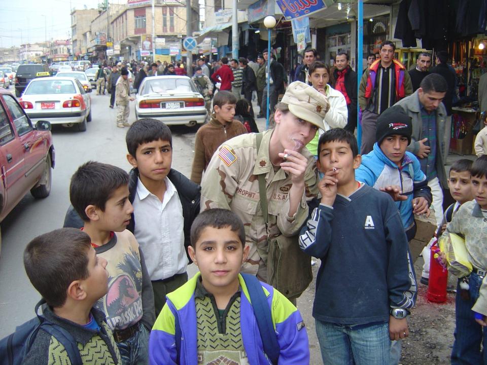 Ravand Al Dosaki, then 11, smoking on the streets of Duhok in Kurdish Iraq on Dec. 6, 2004, when U.S. Army Col. Mary Prophit grabbed a cigarette and pretended to smoke with him as a joke