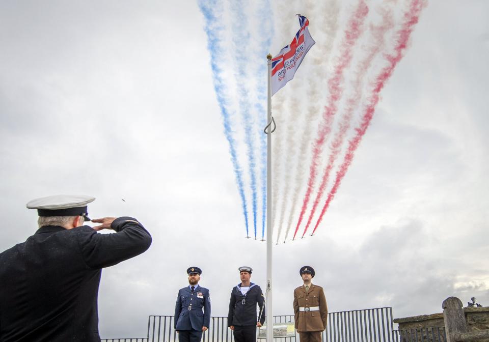 The Red Arrows perform a flypast over an Armed Forces Day flag in the grounds of Scarborough Castle in North Yorkshire (Danny Lawson/PA Wire)