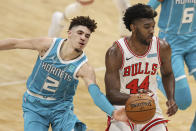 Charlotte Hornets guard LaMelo Ball (2) tries to knock the ball away from Chicago Bulls forward Patrick Williams (44) during the second half of an NBA basketball game in Charlotte, N.C., Thursday, May 6, 2021. (AP Photo/Nell Redmond)