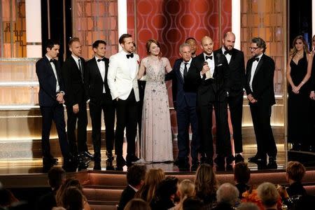 Producers Jordan Horowitz and Fred Berger accept the award for Best Motion Picture - Musical or Comedy for "La La Land" during the 74th Annual Golden Globe Awards show in Beverly Hills, California, U.S., January 8, 2017. Paul Drinkwater/Courtesy of NBC/Handout via REUTERS