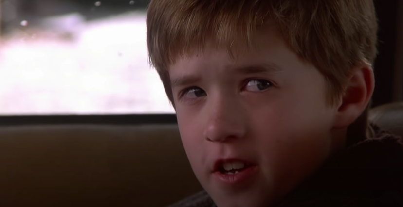 A child talks to his mother in the car