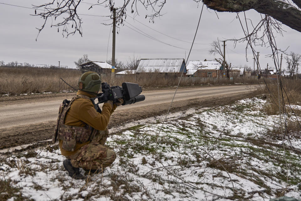 In this photo provided by the Ukrainian 10th Mountain Assault Brigade "Edelweiss", a Ukrainian soldier holds an anti-drone gun on his position near Bakhmut, Donetsk region, Ukraine, Thursday, Nov. 23, 2023. (Shandyba Mykyta, Ukrainian 10th Mountain Assault Brigade "Edelweiss" via AP)