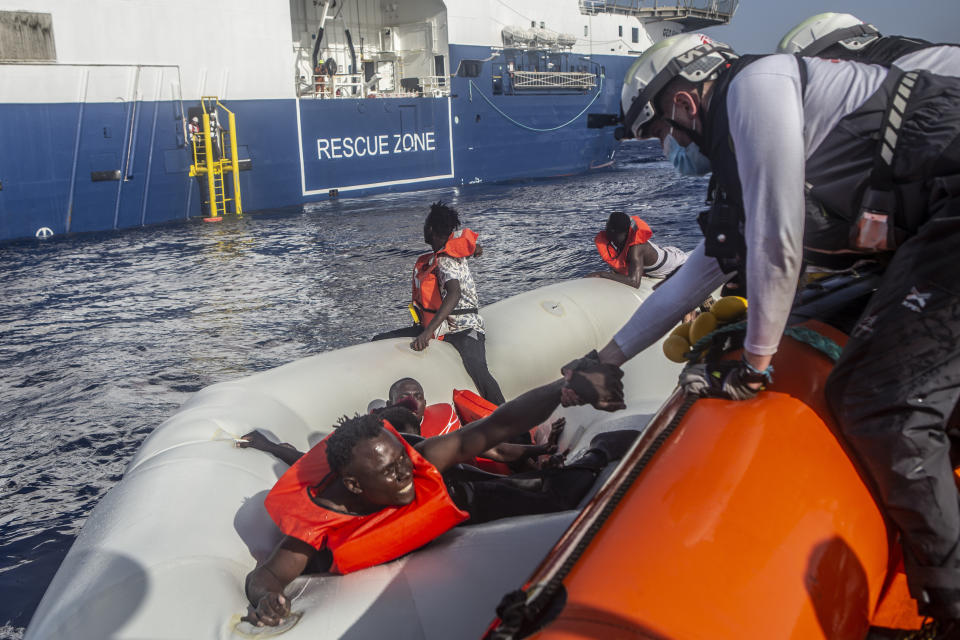 In tis photo released by Doctors Without Borders and taken on June 27, the MSF team rescues 71 people from a rubber boat in distress. A flimsy rubber boat collapsed and sank in the Mediterranean Sea off Libya's coast, leaving at least 30 people including women and children missing and feared dead, the international charity said Wednesday, June 29, 2022. It marked the latest tragedy at sea involving migrants seeking a better life in Europe. (Anna Pantelia/MSF via AP)