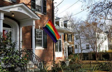 FILE PHOTO: A home flies the rainbow flag in solidarity with the LGBT community two doors down from U.S. Vice President-elect Mike Pence's rental home (white house, far right) in Washington, U.S., December 2, 2016. REUTERS/Gary Cameron/File Photo