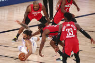 Houston Rockets guard James Harden (13) snd Oklahoma City Thunder center Steven Adams, left, go for the ball during the third quarter of Game 2 of an NBA basketball first-round playoff series, Thursday, Aug. 20, 2020, in Lake Buena Vista, Fla. (Kim Klement/Pool Photo via AP)