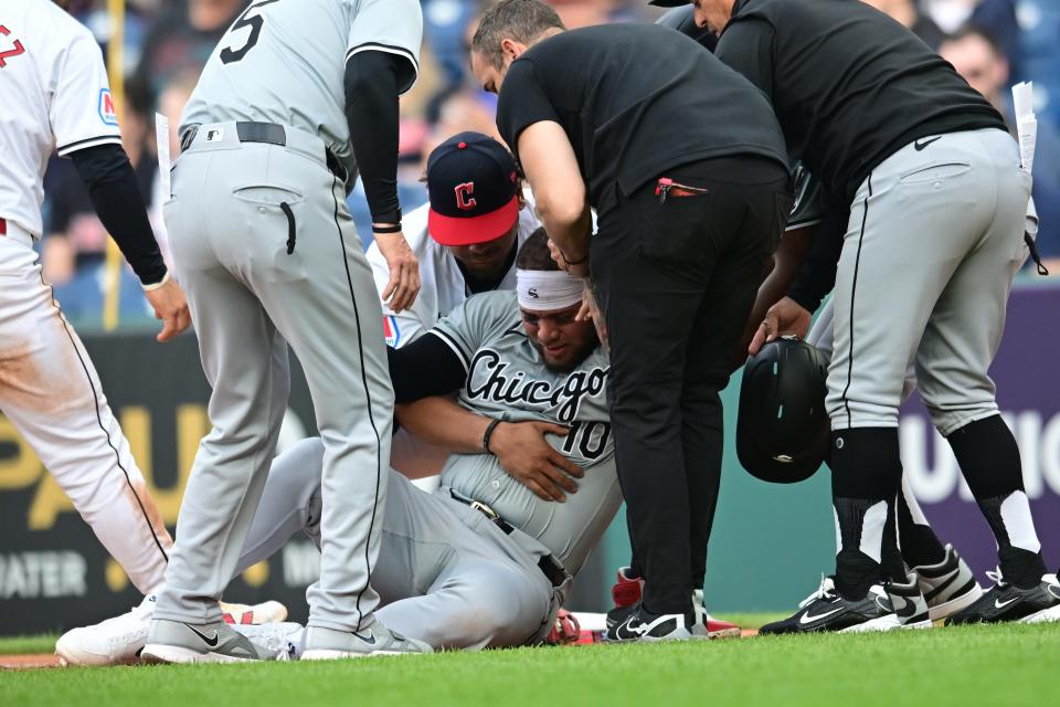 Yoan Moncada is helped up after being injured during the second inning against the Guardians.