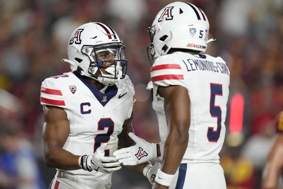 Arizona wide receiver Jacob Cowing (2) celebrates his touchdown catch against Southern California with Montana Lemonious-Craig during the first half of an NCAA college football game Saturday, Oct. 7, 2023, in Los Angeles. (AP Photo/Marcio Jose Sanchez)