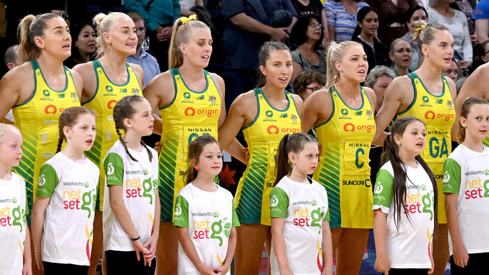 Diamonds players are pictured lined up for the national anthem.