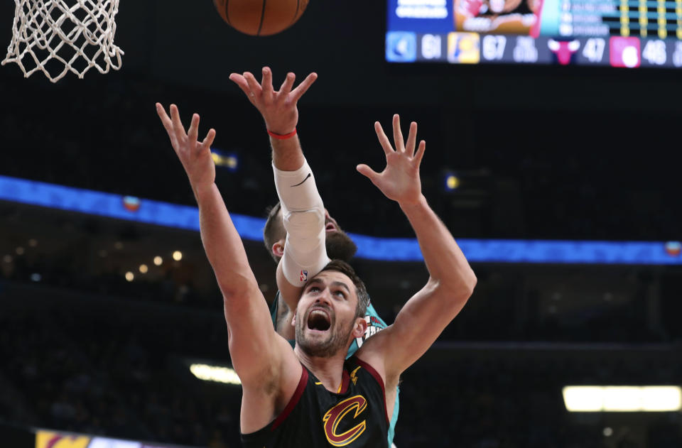 Memphis Grizzlies center Jonas Valanciunas, top, and Cleveland Cavaliers forward Kevin Love reach for a rebound during the first half of an NBA basketball game Friday, Jan. 17, 2020, in Memphis, Tenn. (AP Photo/Karen Pulfer Focht)