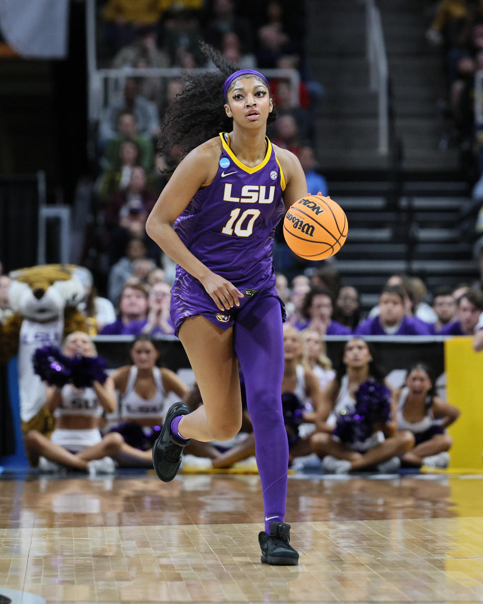 LSU women's basketball player in action, dribbling the ball on the court during a game