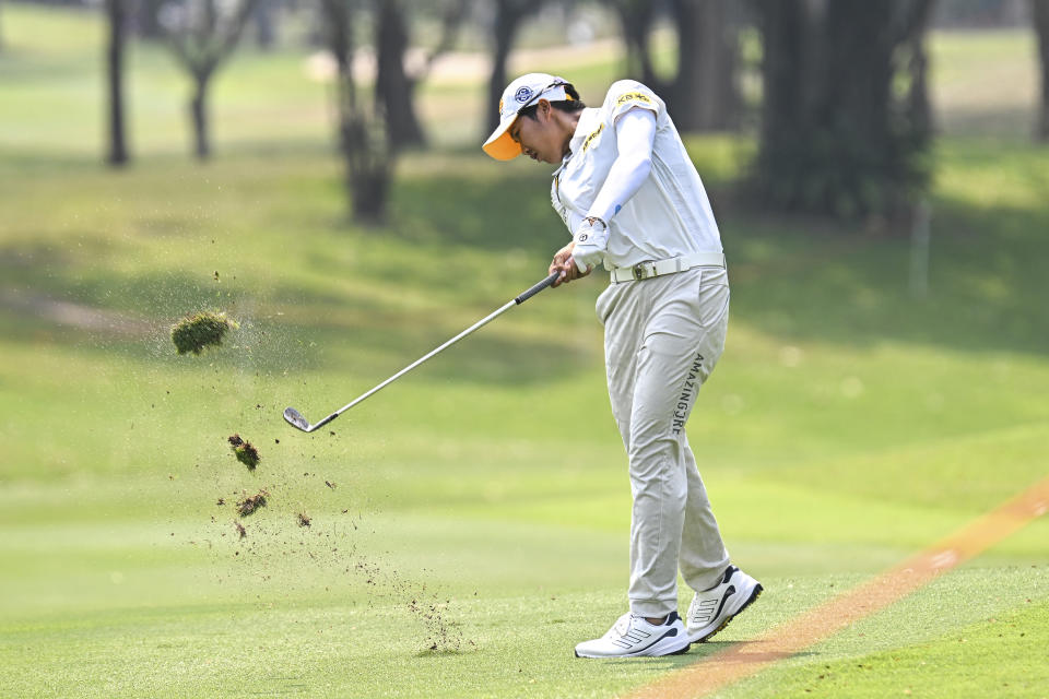 Natthakritta Vongtaveelap of Thailand watches her shot on the fifth hole during the final round of the LPGA Honda Thailand golf tournament in Pattaya, southern Thailand, Sunday, Feb. 26, 2023. (AP Photo/Kittinun Rodsupan)