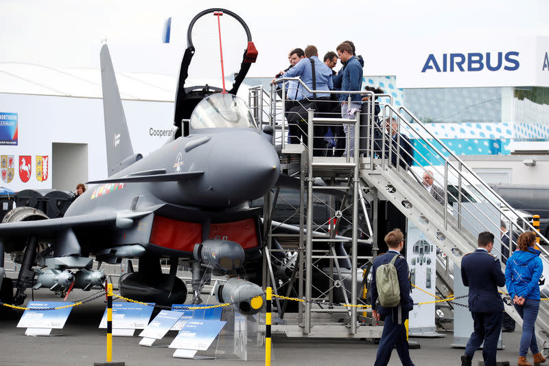 Visitors look at the Eurofighter Typhoon jet during the ILA Air Show in Berlin, Germany, April 25, 2018. REUTERS/Fabrizio Bensch