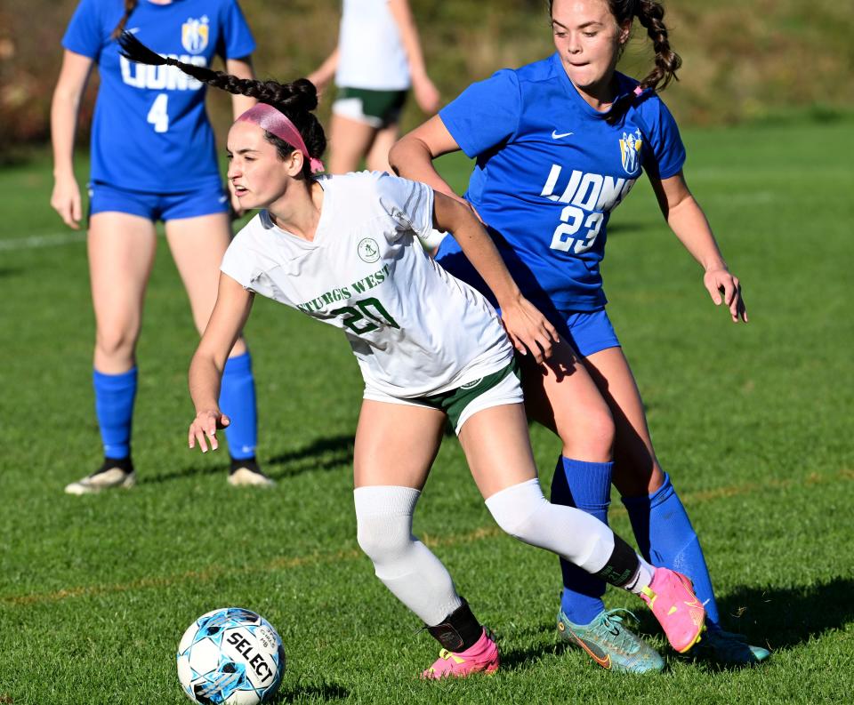 Maddy Ward of Sturgis West moves the ball away from Emma Copllette of St. John Paul II.