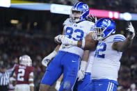 BYU tight end Isaac Rex (83) celebrates with teammates after scoring a 43-yard touchdown against Stanford during the first half of an NCAA college football game in Stanford, Calif., Saturday, Nov. 26, 2022. (AP Photo/Godofredo A. Vásquez)