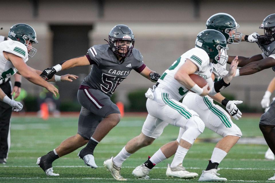 Benedictine’s Wilkes Albert fights through Westminster’s blocker to make the tackle in a recent game.