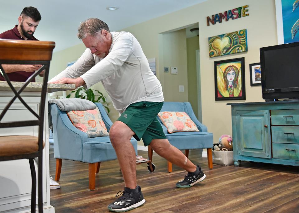 Pat Calhoon does therapy at his Osprey home under the watchful eye of physical therapist Louis DiFiore of On the Go Therapy Services Inc. The 67-year-old Calhoon underwent double knee replacement nine weeks ago.
