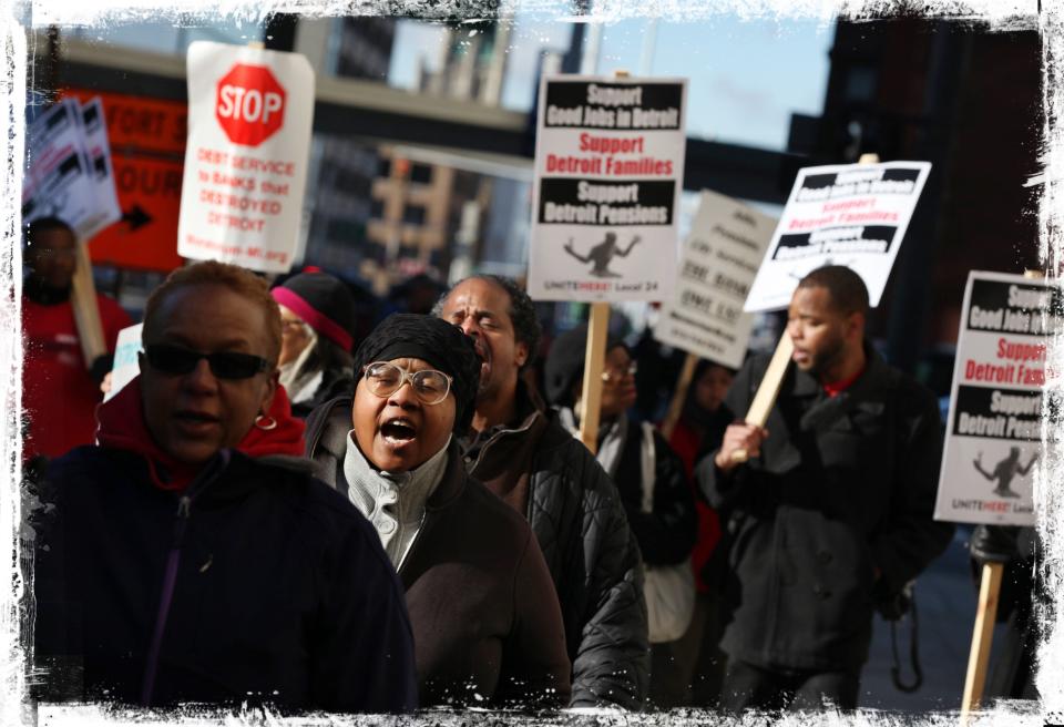 Hundreds of rally in front of the federal courthouse in Detroit during a bankruptcy hearing on Oct. 23, 2013. City pensioners and workers eventually agreed to cuts made smaller by the grand bargain.