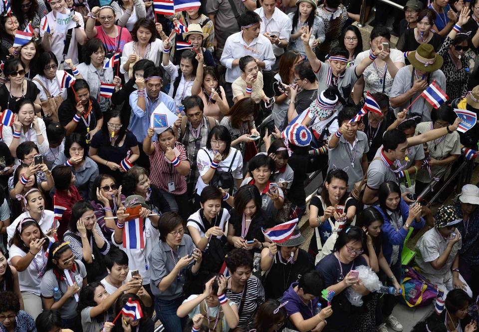Office workers join anti-government protesters during an impromptu demonstration in central Bangkok