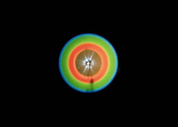 This pattern is created when scientists send a laser beam through a crystal, occasionally producing a connected pair of twin photos. These photons will always be separated from each other by 180 around the circle.