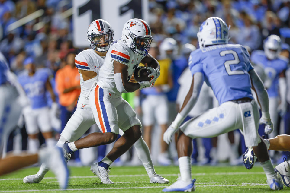 Oct 21, 2023; Chapel Hill, North Carolina, USA; Virginia Cavaliers running back Mike Hollins (7) rushes for a touchdown against the North Carolina Tar Heels in the first half at Kenan Memorial Stadium. Mandatory Credit: Nell Redmond-USA TODAY Sports