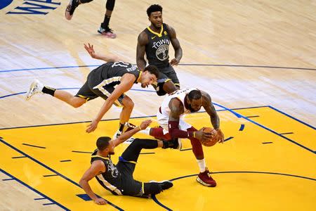 June 3, 2018; Oakland, CA, USA; Golden State Warriors guard Stephen Curry (30) trips Cleveland Cavaliers forward LeBron James (23) during the third quarter in game two of the 2018 NBA Finals at Oracle Arena. Kyle Terada-USA TODAY Sports