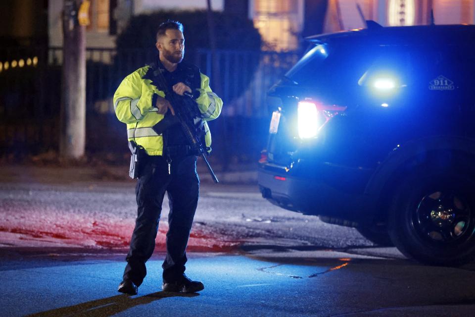 A police officer mans a road block on a street leading to New Hampshire Hospital, Friday, Nov. 17, 2023, in Concord, N.H. A shooter killed one person Friday in the lobby of the psychiatric hospital and then was fatally shot by a state trooper, officials said. (AP Photo/Michael Dwyer)