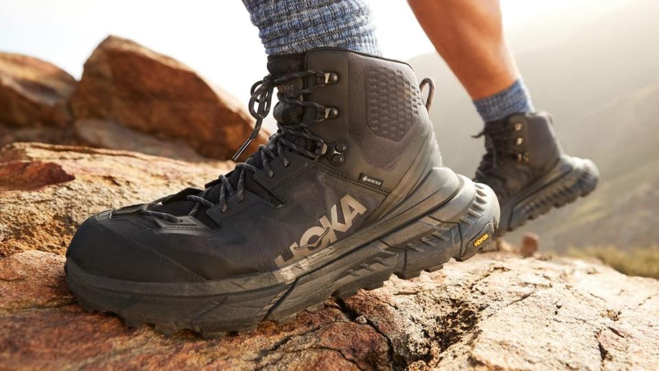 Person's feet wearing Hoka OneOne TenNine Hike boots