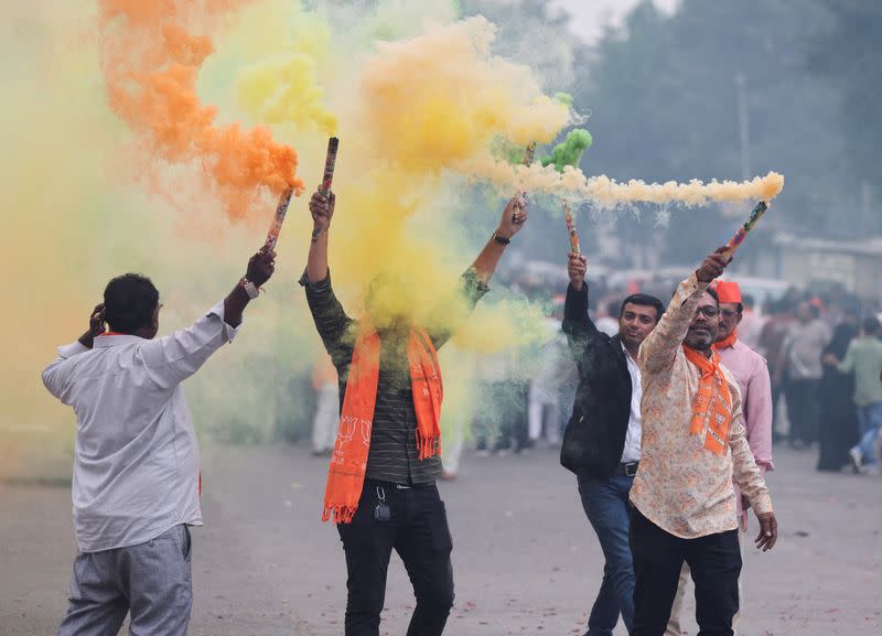 FILE PHOTO: Supporters of India's ruling Bharatiya Janata Party (BJP) celebrate after winning three out of four states in key regional polls outside the party headquarters in Ahmedabad