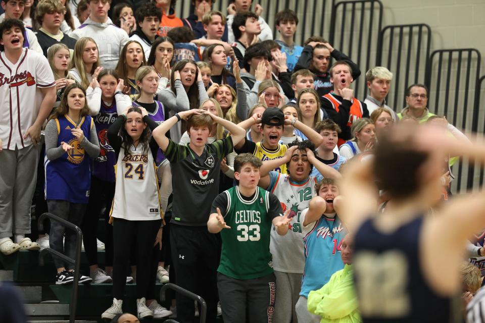 Pittsford Sutherland fans react to the score during the team's Section V semifinal game against Monroe High at Rush-Henrietta High School.