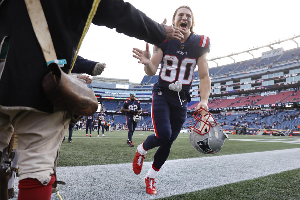 New England Patriots wide receiver Gunner Olszewski (80) is congratulated by the End Zone Militia, a historically dressed reenactment unit, after defeating the New York Jets 54-13 following an NFL football game, Sunday, Oct. 24, 2021, in Foxborough, Mass. (AP Photo/Mary Schwalm)