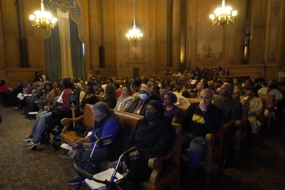 People listen to speakers during a special Board of Supervisors hearing about reparations in San Francisco, Tuesday, March 14, 2023. Supervisors in San Francisco are taking up a draft reparations proposal that includes a $5 million lump-sum payment for every eligible Black person. (AP Photo/Jeff Chiu)