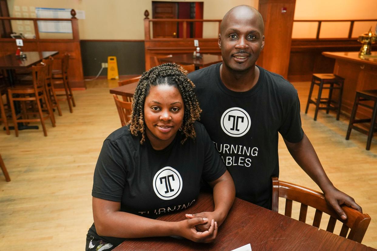 Emerald Mills poses for a portrait with her husband, Jervel Williams, in August 2022 at Turning Tables Tavern in the historic Turner Hall in downtown Milwaukee. Turning Tables serves diners while training chefs.