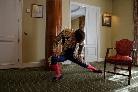 Alberto Lamelas stretches out wearing his bullfighter outfit in a hotel room before taking part in a bullfighting during San Isidro festival at Las Ventas bullring in Madrid, Spain, June 5, 2017. REUTERS/Sergio Perez