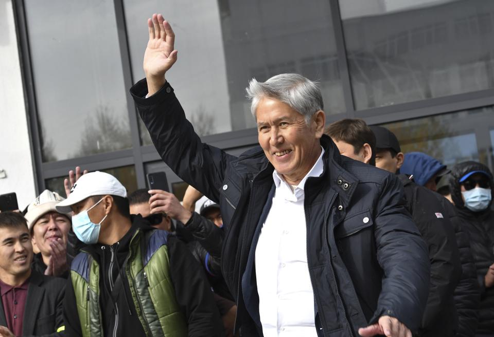 Former President Almazbek Atambayev waves to his supporters in Bishkek, Kyrgyzstan, Friday, Oct. 9, 2020. Sooronbai Jeenbekov, the embattled president of Kyrgyzstan, has moved to end the political turmoil that followed a disputed parliamentary election, ordering a state of emergency in the capital. Jeenbekov has faced calls to resign by protesters who stormed government buildings after Sunday’s parliamentary vote was reportedly swept by pro-government parties. Protesters freed former President Almazbek Atambayev, who was jailed on charges seen by his supporters as a political vendetta. (AP Photo/Vladimir Voronin)