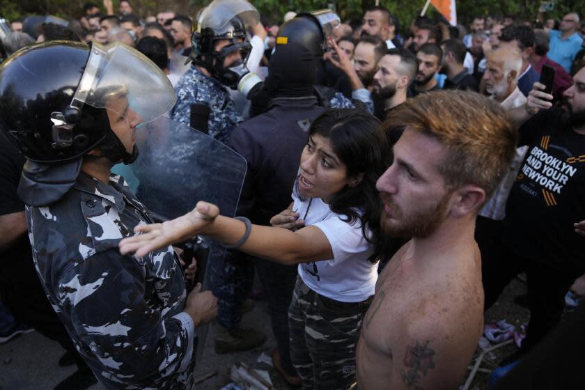 Lebanese Armenians clash with police outside the Azerbaijani embassy in Beirut, Lebanon, Thursday, Sept. 28, 2023. The scuffles came during their protest on Thursday to denounce the Azerbaijani military offensive that recaptured Nagorno-Karabakh from the separatist Armenian authorities in the enclave. (AP Photo/Hussein Malla)