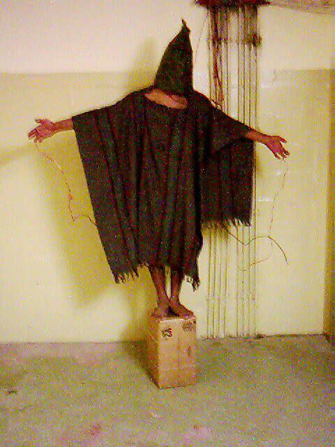 An unidentified detainee is forced to stand on a box with a bag over his head and wires attached to him in late 2003 at the Abu Ghraib prison in Baghdad. (Photo: Associated Press)