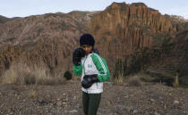 Gracce Kelly Flores, a 12-year-old boxer who goes by the nickname Hands of Stone, poses for a photo as she trains under the coaching of her father in Palca, Bolivia, early Thursday, June 10, 2021, amid the COVID-19 pandemic. At age 8, Flores defeated a 10-year-old boy, and with three national boxing medals under her belt, she dreams of reaching the women's boxing world championship. (AP Photo/Juan Karita)