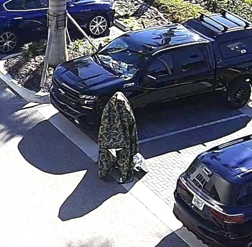 Naples police said a Pierson man, Micah Weiss Bennett, 26 is seen on Friday in a Jaguar dealership's surveillance video covered in a military-style camouflage tarp walking in the parking lot near the entrance. He was armed with a 30-30 rifle and his sudden appearance caused mass panic of staff and customers, police said.