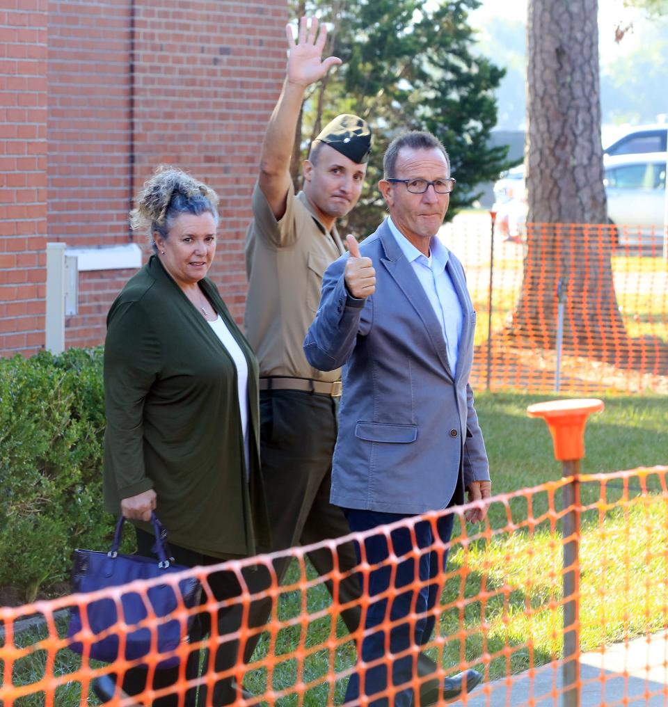 Lt. Col. Stuart Scheller Jr. (center) with his parents Cathy Scheller and Stuart Scheller Sr. following Scheller Jr.'s court-martial at Camp Lejeune NC,  Friday October 15, 2021.