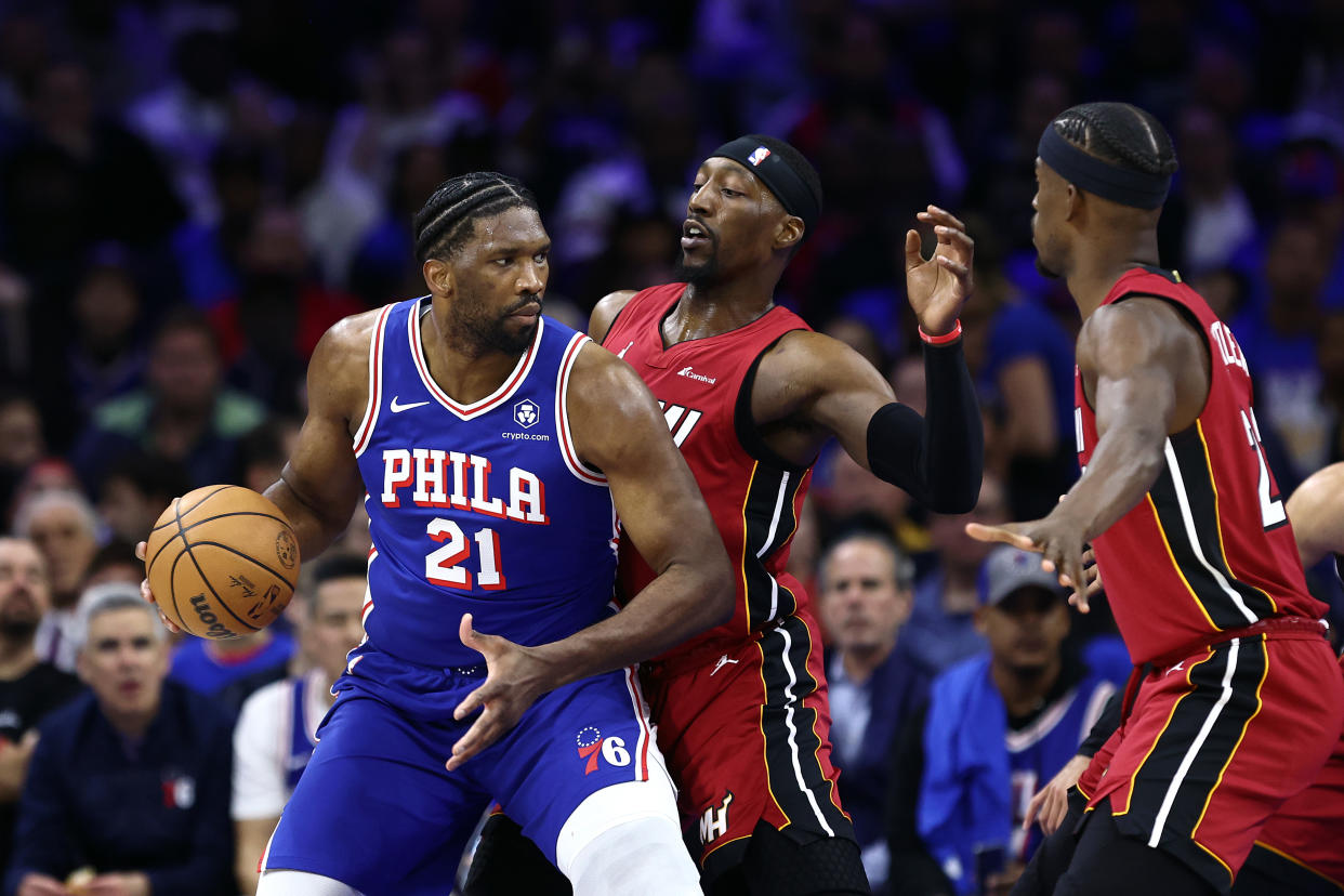 PHILADELPHIA, PENNSYLVANIA - APRIL 17: Joel Embiid #21 of the Philadelphia 76ers is guarded by Bam Adebayo #13 of the Miami Heat during the third quarter during the Eastern Conference Play-In Tournament at the Wells Fargo Center on April 17, 2024 in Philadelphia, Pennsylvania. NOTE TO USER: User expressly acknowledges and agrees that, by downloading and or using this photograph, User is consenting to the terms and conditions of the Getty Images License Agreement. (Photo by Tim Nwachukwu/Getty Images)