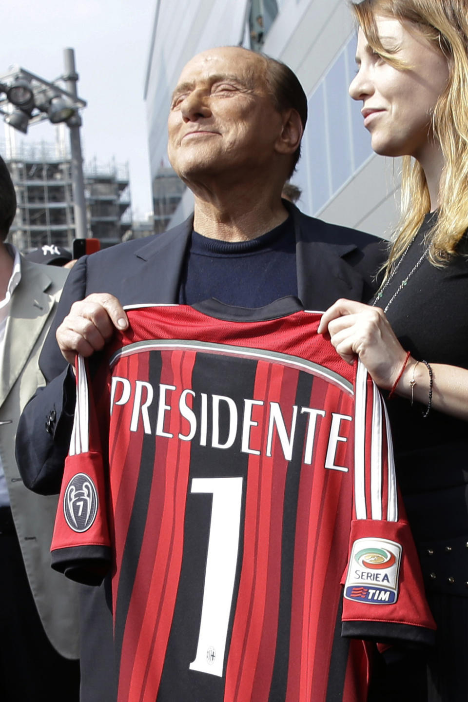 FILE - AC Milan president Silvio Berlusconi, left, holds a Milan shirt flanked by his daughter Barbara during a visit to the new team headquarter in Milan, Italy, on June 6, 2014. From his grand entrance by helicopter after buying AC Milan to empowering Monza up to Serie A for the first time in its history, Silvio Berlusconi dominated Italian soccer for decades just like he commanded the show in Italian politics. Berlusconi, a former three-time Italian premier, died Monday, according to his television network. He was 86. (AP Photo/Luca Bruno, File)